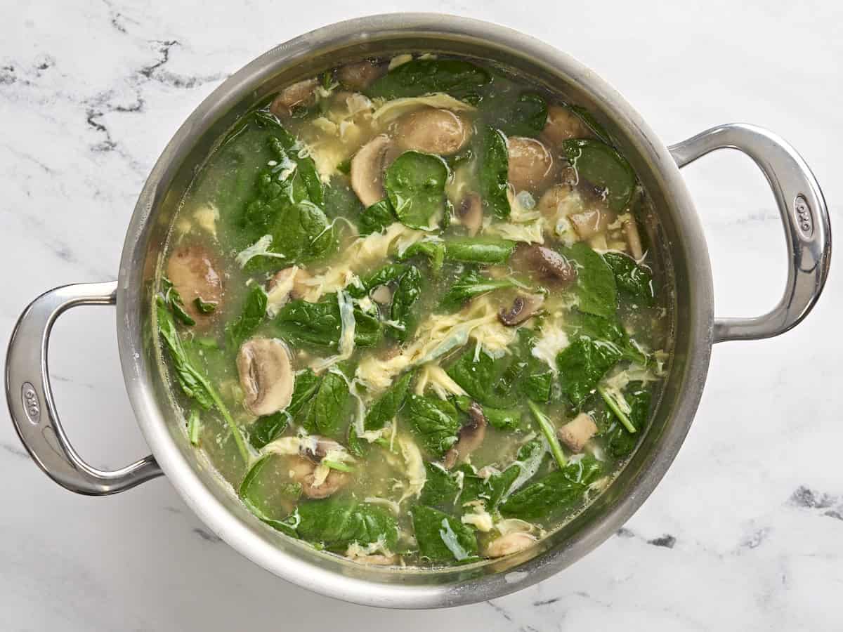 This fast and easy homemade egg drop soup is warm and soothing on cold days or when you're feeling under the weather. Comes together in under 30 minutes! BudgetBytes.com Finished egg drop soup in a soup pot.