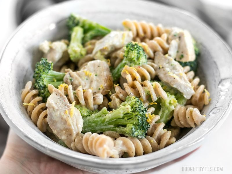 This super luscious Chicken and Broccoli Pasta with Lemon Cream Sauce comes together quickly for a weeknight dinner and uses only a few simple ingredients. BudgetBytes.com Front close up of a bowl of Chicken and Broccoli Pasta with Lemon Cream Sauce