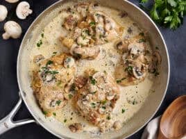 Overhead view of creamy mushroom chicken in a skillet.