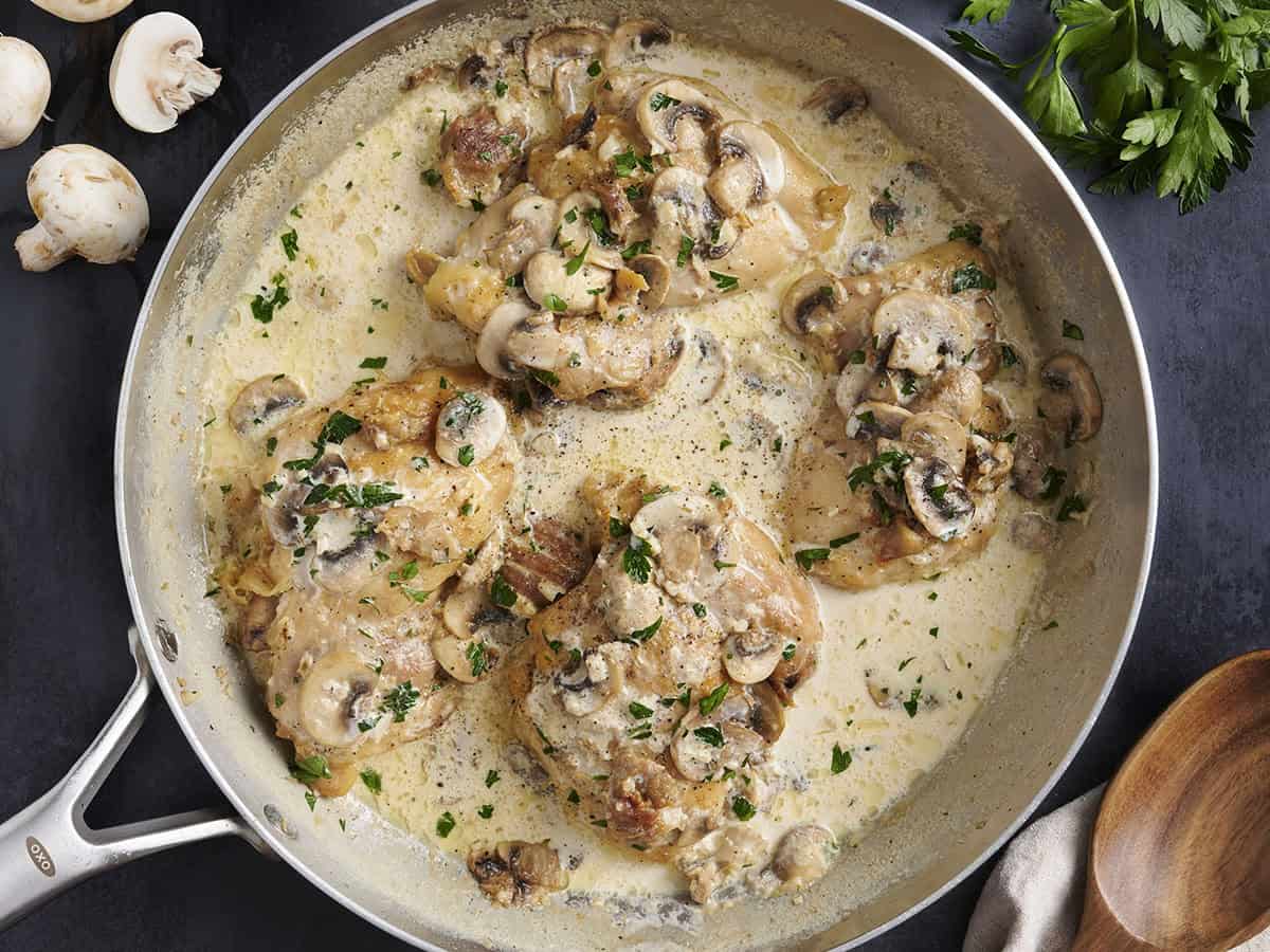 Overhead view of creamy mushroom chicken in a skillet.