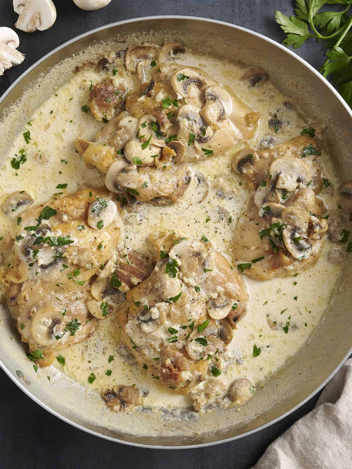 Overhead view of creamy mushroom chicken in a skillet.
