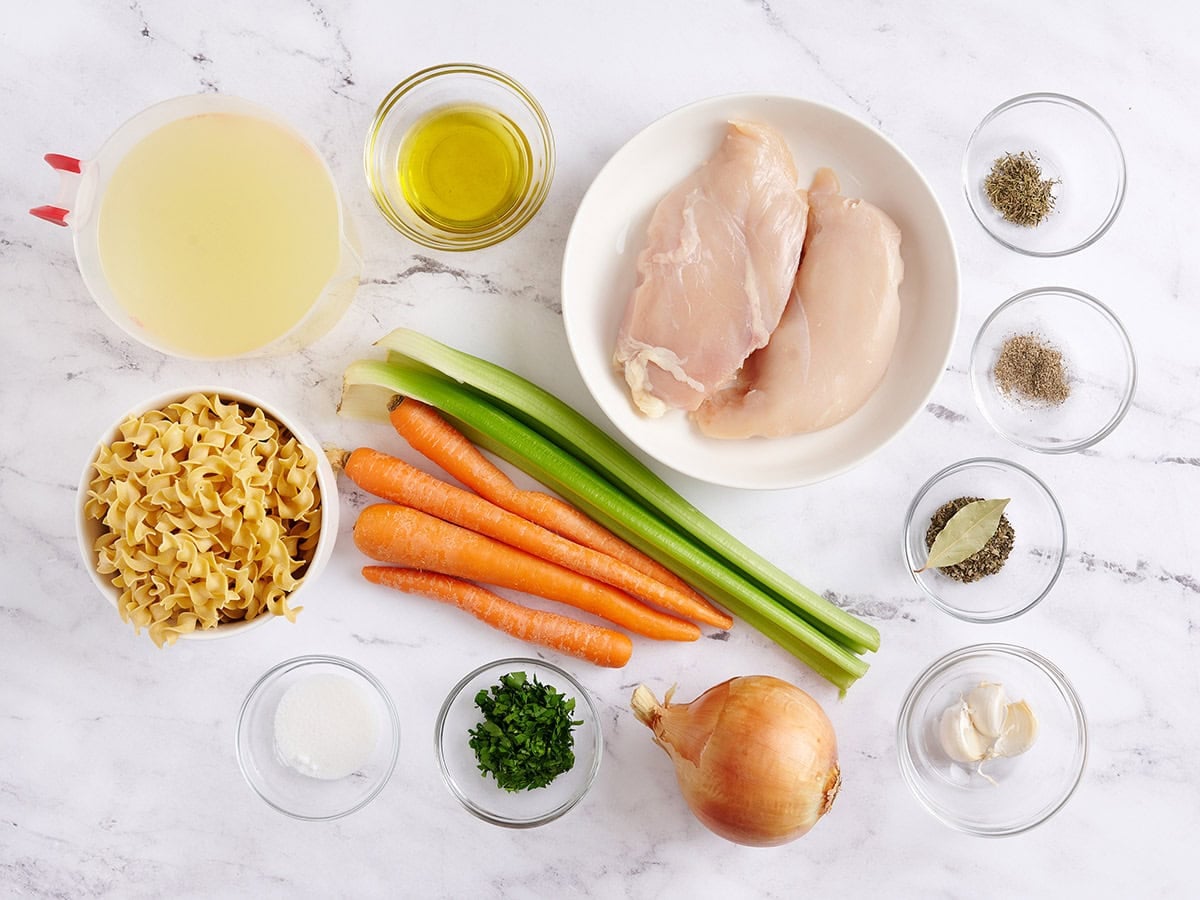 The ingredients to make homemade chicken noodle soup.