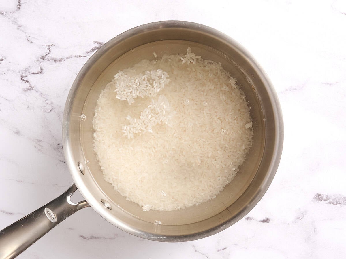 Rice cooking in water in a sauce pan
