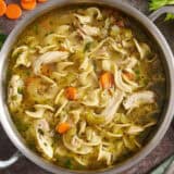 Overhead view of a pot of homemade chicken noodle soup.