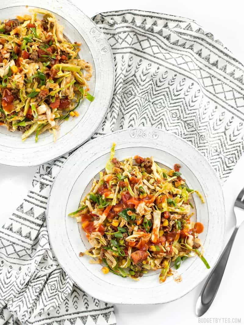 This Southwest Beef and Cabbage Stir Fry is a fast, easy, and flavorful way to make sure dinner is filled with plenty of vegetables. BudgetBytes.com Two plates of Southwest Beef and Cabbage Stir Fry on a patterned napkin