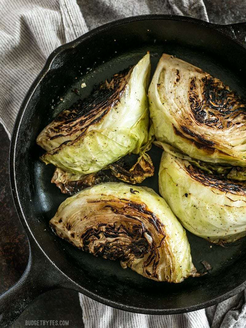 Blackened Cabbage is a fast and simple side dish that pairs beautifully with any grilled or BBQ meat. Add a creamy chipotle mayo for extra punch. BudgetBytes.com Blackened Cabbage wedges in a cast iron skillet
