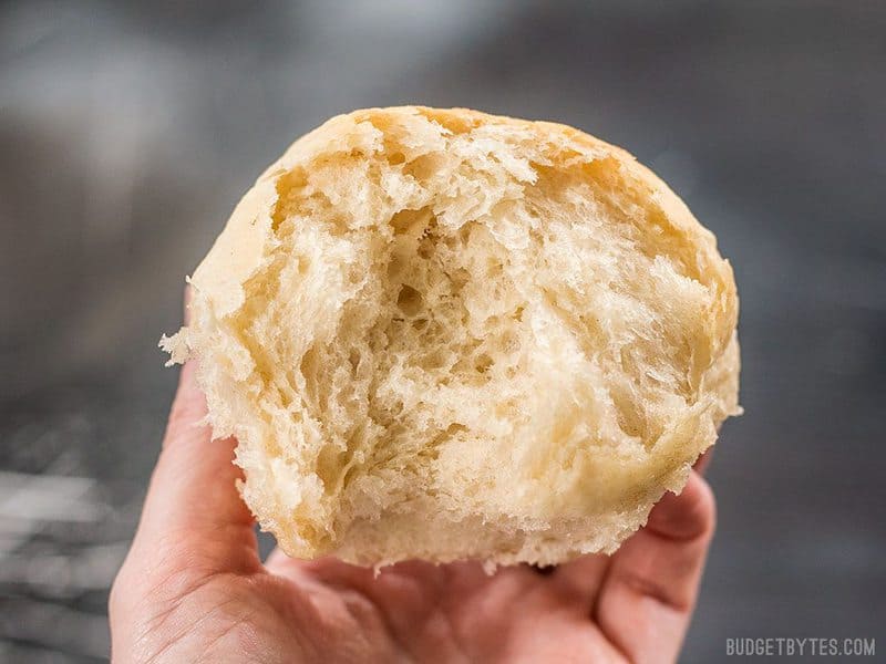 These incredible light and delicate Buttermilk Pull-Apart Rolls couldn't be easier thanks to a simple no-knead dough. BudgetBytes.com Close up of one Buttermilk Pull-Apart Rolls broken in half
