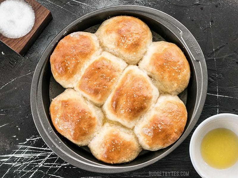 These incredible light and delicate Buttermilk Pull-Apart Rolls couldn't be easier thanks to a simple no-knead dough. BudgetBytes.com Overhead shot of the Buttermilk Pull-Apart Rolls in the round baking pan
