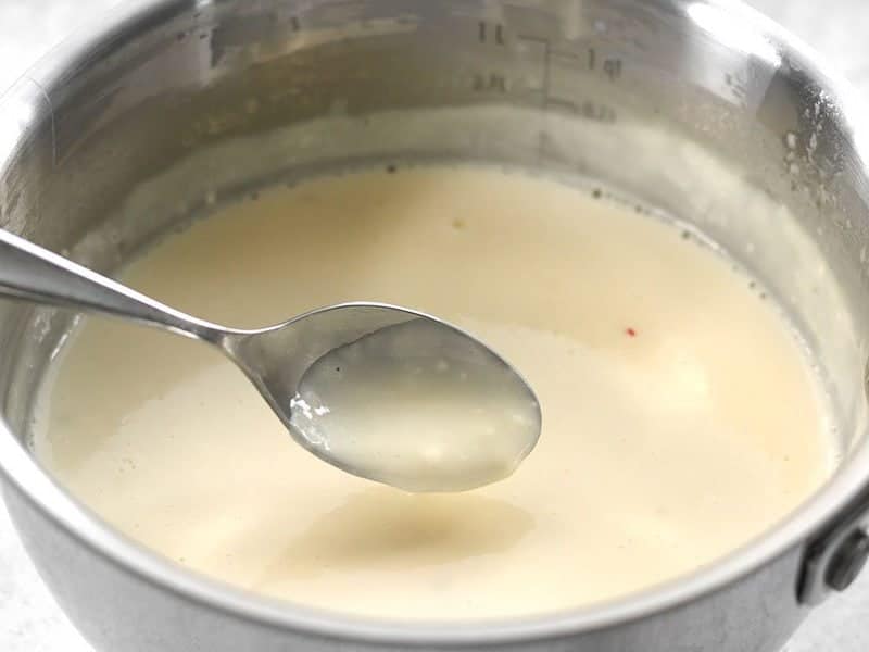 Spoon coated with melted pepper jack sauce