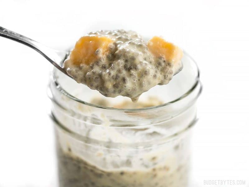 These Mango Coconut Chia Pudding cups are a fast and easy make-ahead breakfast with tons of fiber and protein. BudgetBytes.com Close up of a spoonful of Mango Coconut Chia Pudding