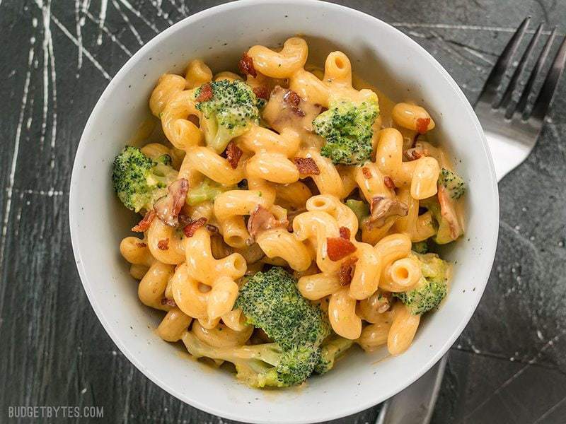 This One Pot Bacon Broccoli Mac and Cheese is fast, easy, and absolutely fool proof. This sauce stays smooth and creamy! BudgetBytes.com Overhead shot of a bowl full of One Pot Bacon Broccoli Mac and Cheese