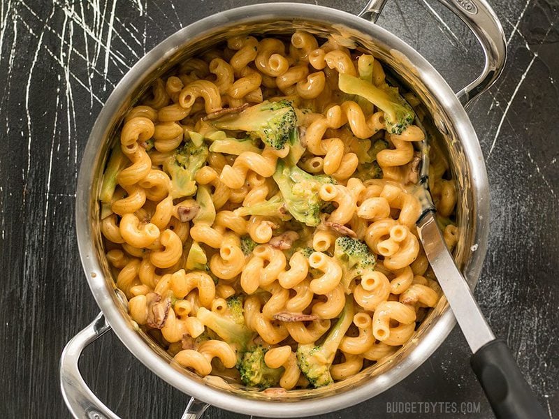 This One Pot Bacon Broccoli Mac and Cheese is fast, easy, and absolutely fool proof. This sauce stays smooth and creamy! BudgetBytes.com Overhead shot of a pot full of One Pot Bacon Broccoli Mac and Cheese