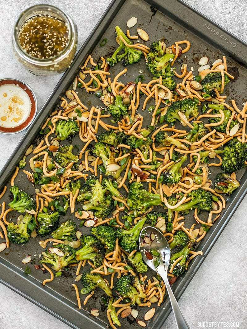 This crunchy, sweet, and salty Roasted Broccoli Salad with Almonds is my favorite way to get my vegetables and goes great with any Asian inspired meal. Budgetbytes.com A sheet pan full of Roasted Broccoli Salad with Almonds and a jar of Simple Sesame Dressing on the side