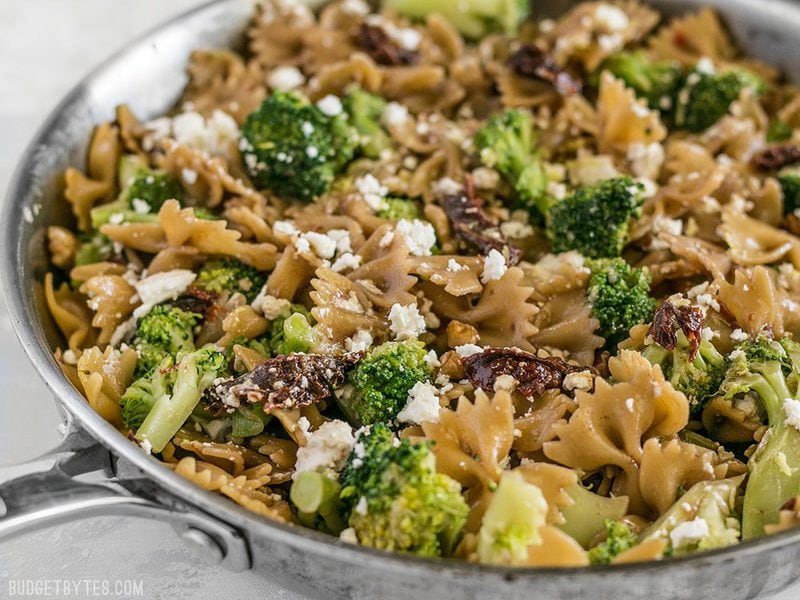 A few pantry staples come together to make a fantastic dinner in this fast, easy, and flavorful one Skillet Pasta with Sun Dried Tomatoes Walnuts and Feta. BudgetBytes.com Skillet Pasta with Sun Dried Tomatoes Walnuts and Feta viewed from the side