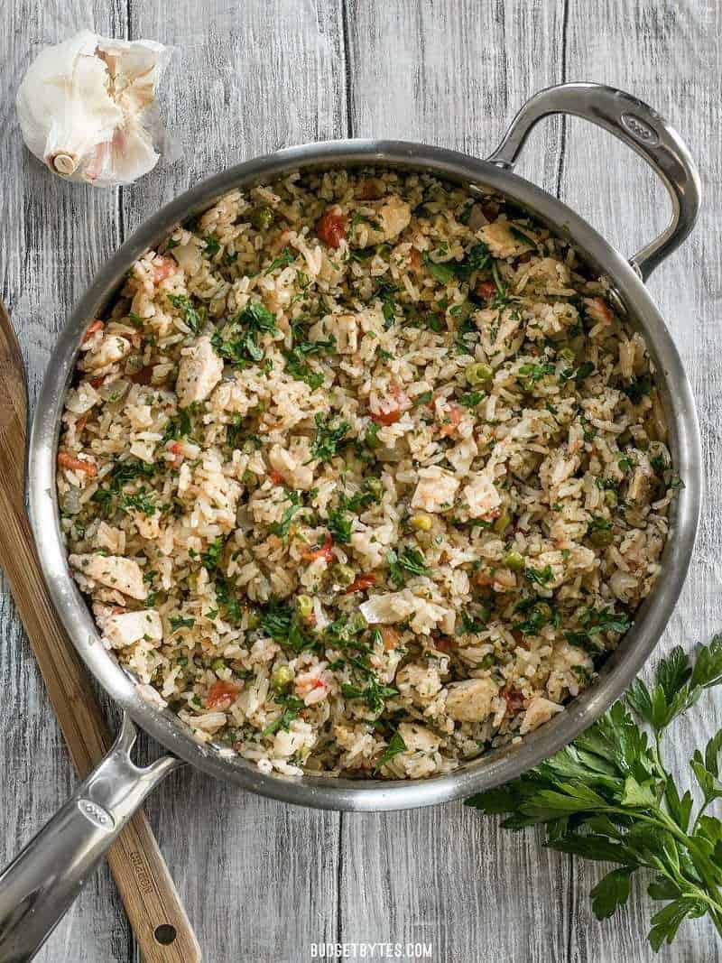 This Chimichurri Chicken and Rice is a bright and vibrant summer meal that cooks in just one pot to make dinner fast and easy. BudgetBytes.com A full skillet of Chimichurri Chicken and Rice from above