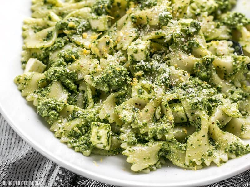 Kale makes a great inexpensive and earthy pesto! Dress up this Kale Pesto pasta with add-ins to make it a meal, or keep it simple for the perfect summer side. BudgetBytes.com Close up of a bowl full of kale pesto pasta
