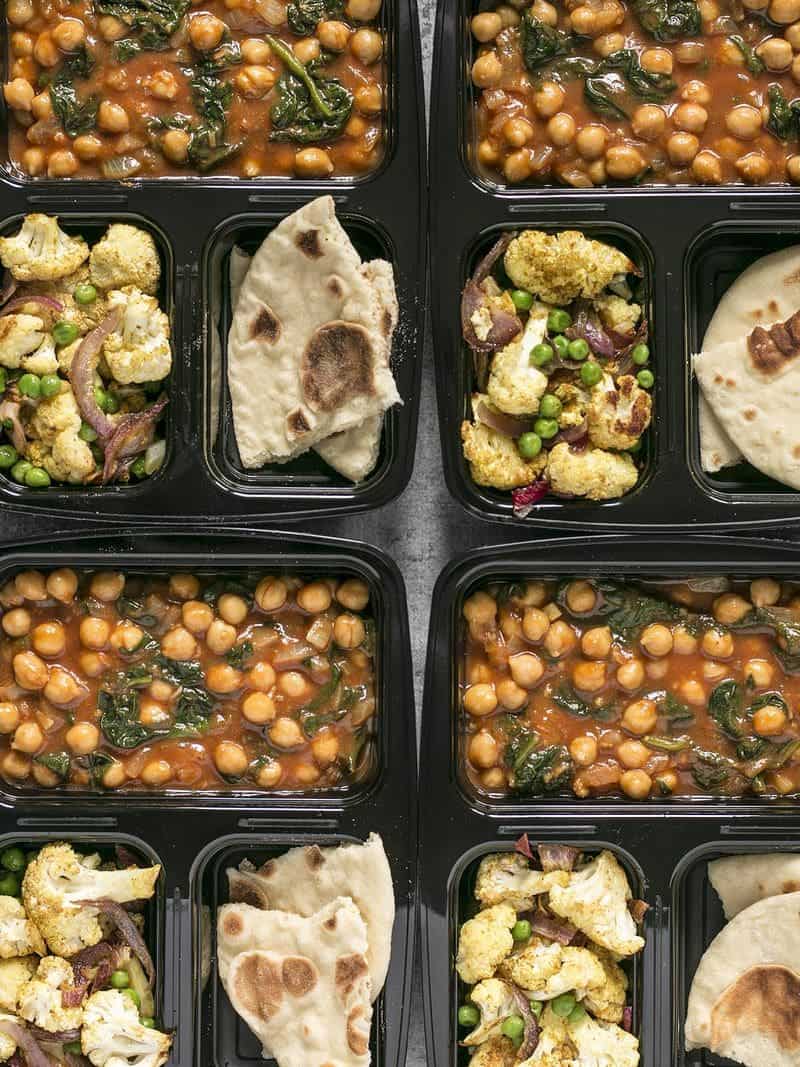 This week's Curried Chickpeas Meal Prep is a filling and flavorful vegetarian meal with a vegan option. BudgetBytes.com Close up of Curried Chickpeas Meal Prep containers lined up