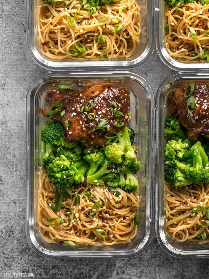 Four glass Sticky Ginger Soy Glazed Chicken Meal Prep containers close up