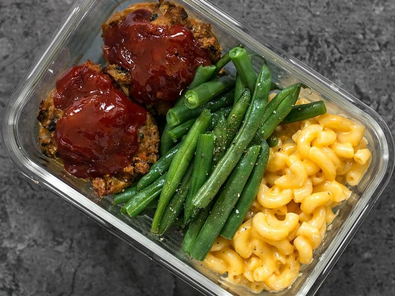 It's comfort food in a box! You'll look forward to eating this veggie-packed Garden Vegetable Turkey Loaf Meal Prep for lunch every day. BudgetBytes.com One glass Garden Vegetable Turkey Loaf Meal Prep container close up