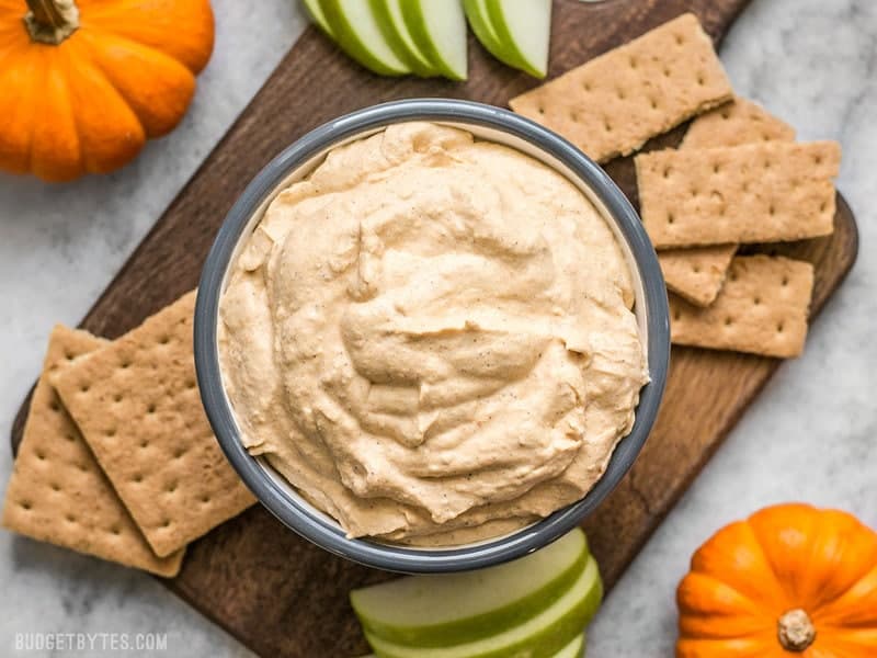 This Pumpkin Cheesecake Mousse is a super light and fluffy no-bake dessert packed with fall spices and just enough sweetness to balance the pumpkin-y flavor. Budgetbytes.com Pumpkin Cheesecake Mousse with graham crackers and apples for dipping.