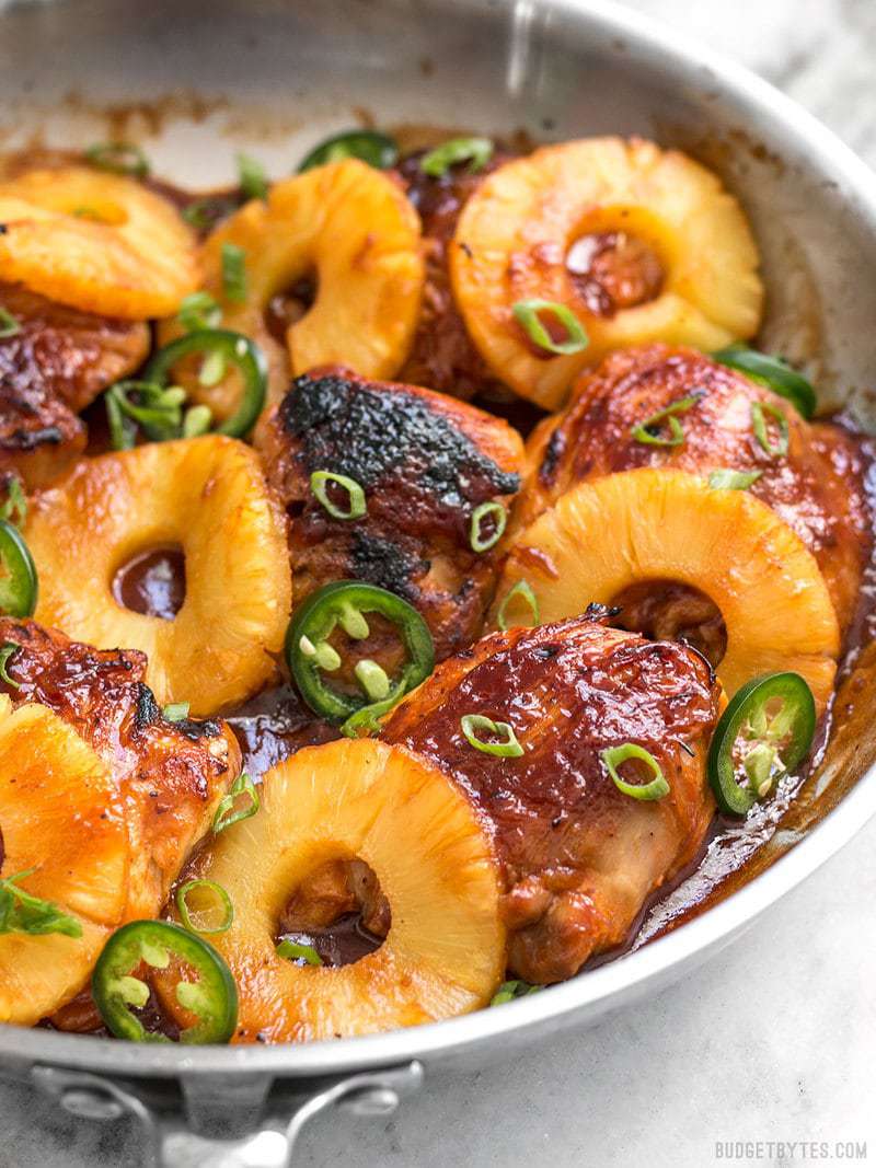 A quick pan sauce drenches tender chicken thighs and thick pineapple slices in this easy Skillet Pineapple BBQ Chicken Side view of finished Skillet Pineapple BBQ Chicken