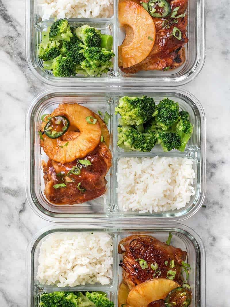This Pineapple BBQ Chicken Meal Prep includes sweet and tangy chicken, rich and savory coconut rice, and tender broccoli florets. BudgetBytes.com Three Pineapple BBQ Chicken Meal Prep containers in a row