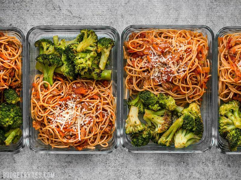 This simple Spaghetti Meal Prep is hiding a ton of good-for-you vegetables in a classic comforting dish. BudgetBytes.com Four Spaghetti Meal Prep containers in a row