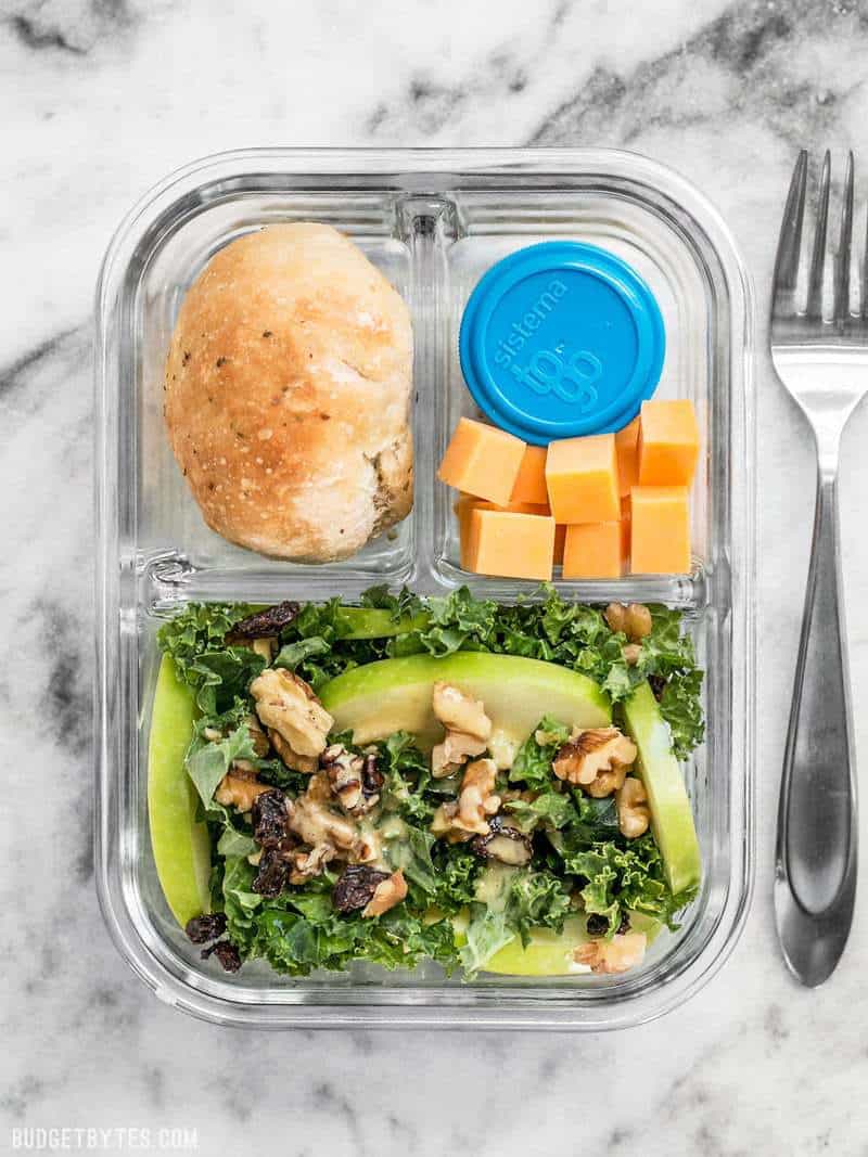 This Apple Dijon Kale Salad Meal Prep is full of texture and bright flavors, and is sure to keep you full for hours. BudgetBytes.com This Apple Dijon Kale Salad Meal Prep container ready to be eaten.