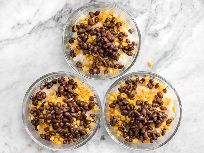 Add seasoned black beans to bowls