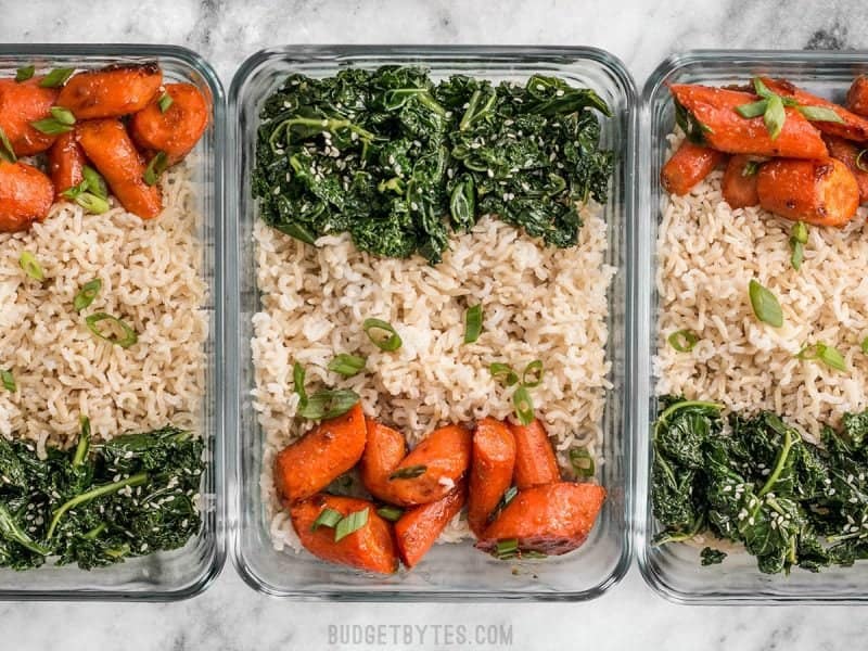This Maple Miso Roasted Carrot Meal prep is easy, healthy, has tons of flavor, and plenty of ways to customize! BudgetBytes.com Three Maple Miso Roasted Carrot Meal prep containers in a row