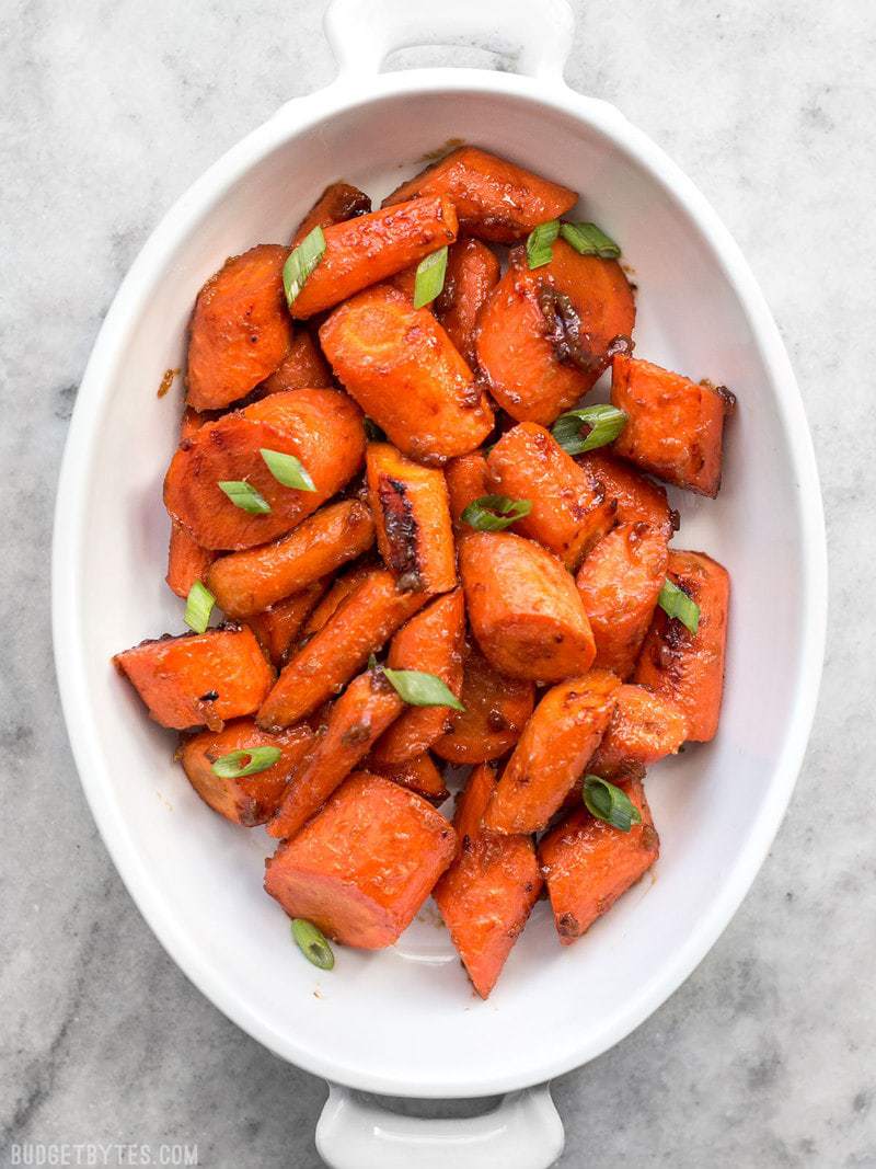 These Maple Miso Roasted Carrots are sweet, savory, and rich, and make a great side dish to any Asian inspired meal. BudgetBytes.com Maple Miso Roasted Carrots in a serving dish