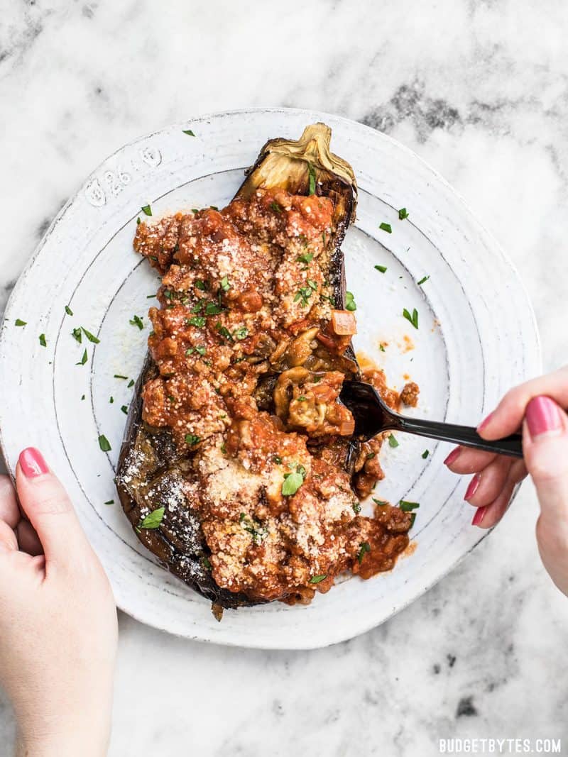 Roasted Eggplant with Meat Sauce is an elegant low carb main dish that will leave you satisfied. Pair with a simple green salad for a complete meal. BudgetBytes.com Roasted Eggplant with Meat Sauce being eaten with a fork