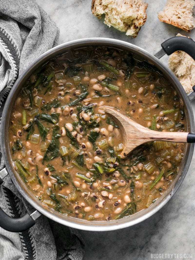 Slow Simmered Black Eyed Peas and Greens is a great cold weather comfort food that is as healthy as it is delicious! Vegan comfort food at its best! Budgetbytes.com Big pot of warm and comforting Slow Simmered Black Eyed Peas with Greens