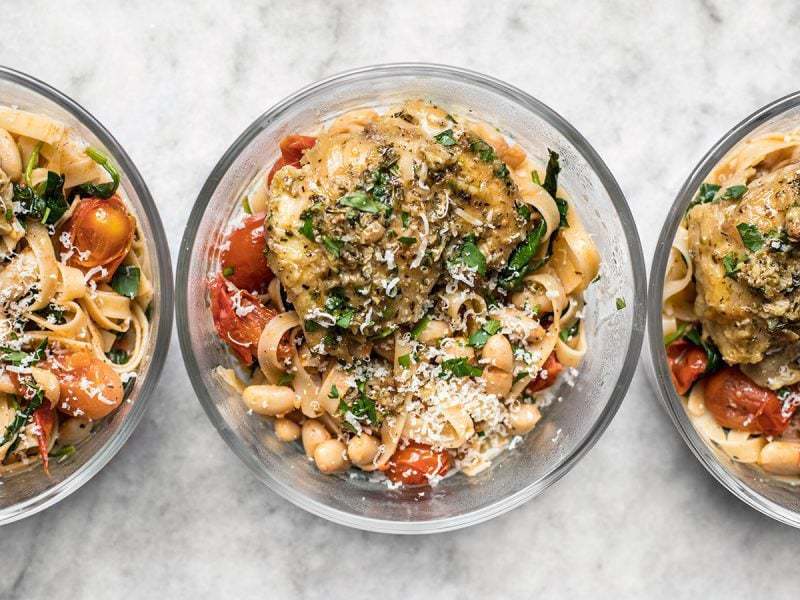 This Herb Butter Chicken Meal Prep covers all the bases (meat, carb, vegetable, and FLAVOR) with just two easy recipes. BudgetBytes.com Glass meal prep containers lined up with Herb Butter Chicken and tuscan white bean pasta