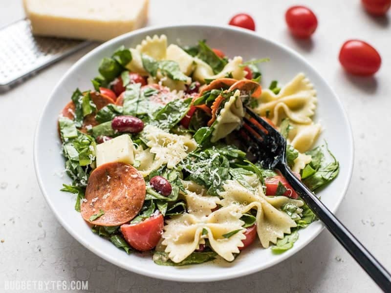 Pepperoni’s rich and peppery bite is the perfect contrast to mild spinach, mozzarella, and pasta in this Pepperoni Pasta Salad. BudgetBytes.com Front view of Pepperoni Pasta Salad in a bowl with a fork