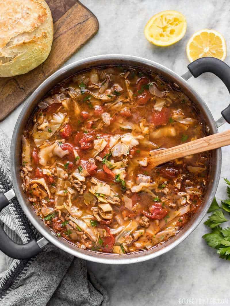 Light, but filling, this Beef and Cabbage Soup will fill you up without weighing you down, and will keep you warm from the inside out. BudgetBytes.com A full pot of finished Beef and Cabbage Soup with bread on the side and a wooden spoon