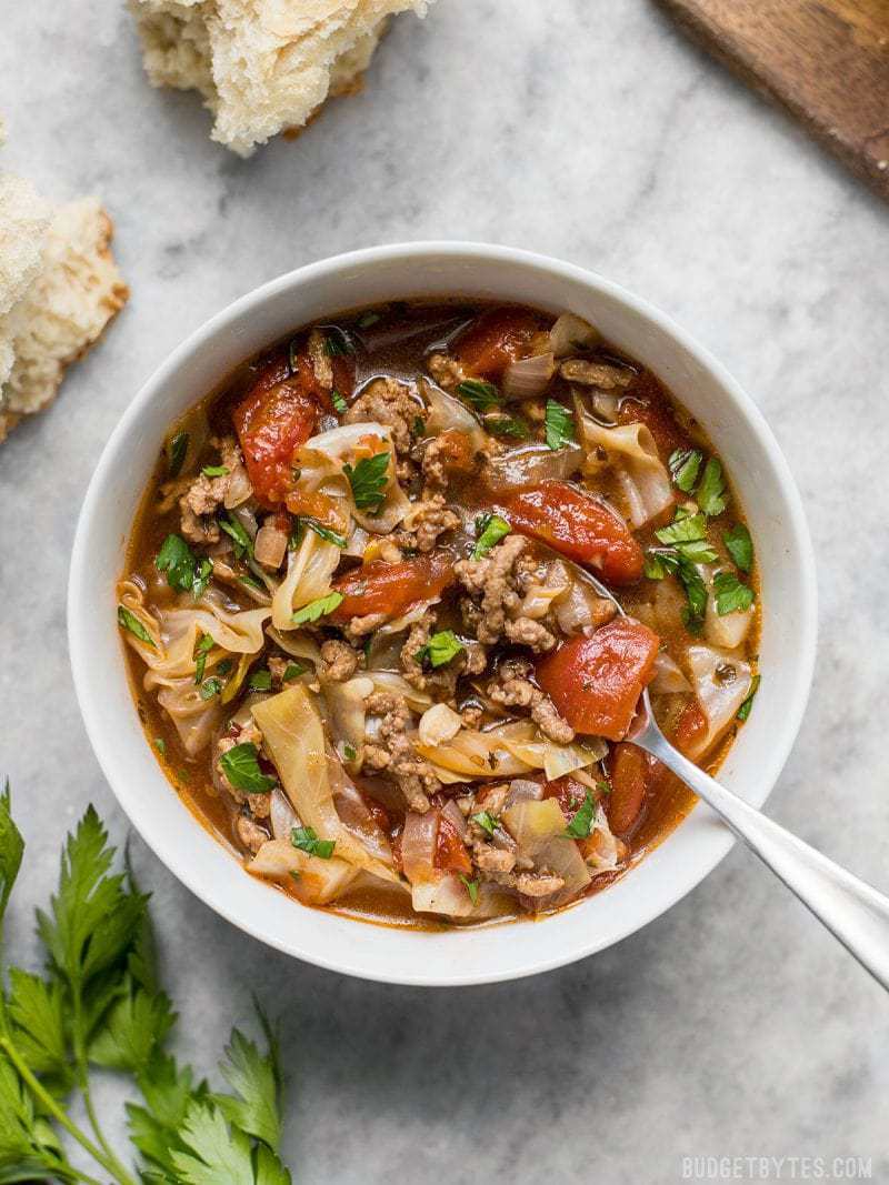 Light, but filling, this Beef and Cabbage Soup will fill you up without weighing you down, and will keep you warm from the inside out. BudgetBytes.com A bowl of Beef and Cabbage Soup with chunks of crusty bread near by