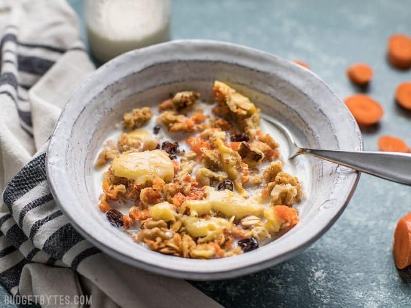 This Carrot Cake Baked Oatmeal is packed with healthy carrots and pops of sweetness from raisins and a cheesecake-inspired topping. Budgetbytes.com A bowl of Carrot Cake Baked Oatmeal with milk ready to be eaten