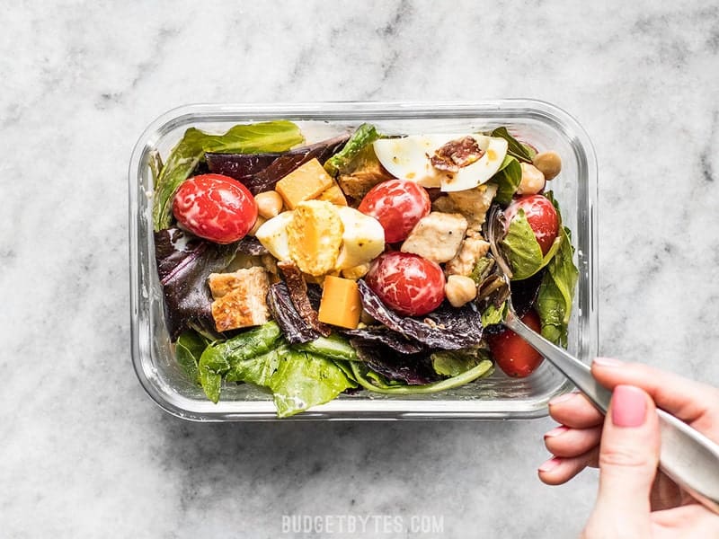 The special layering technique and low-moisture ingredients keep this Cobb Salad Meal Prep fresh and beautiful for days! Budgetbytes.com Stirred Cobb Salad in the meal prep container