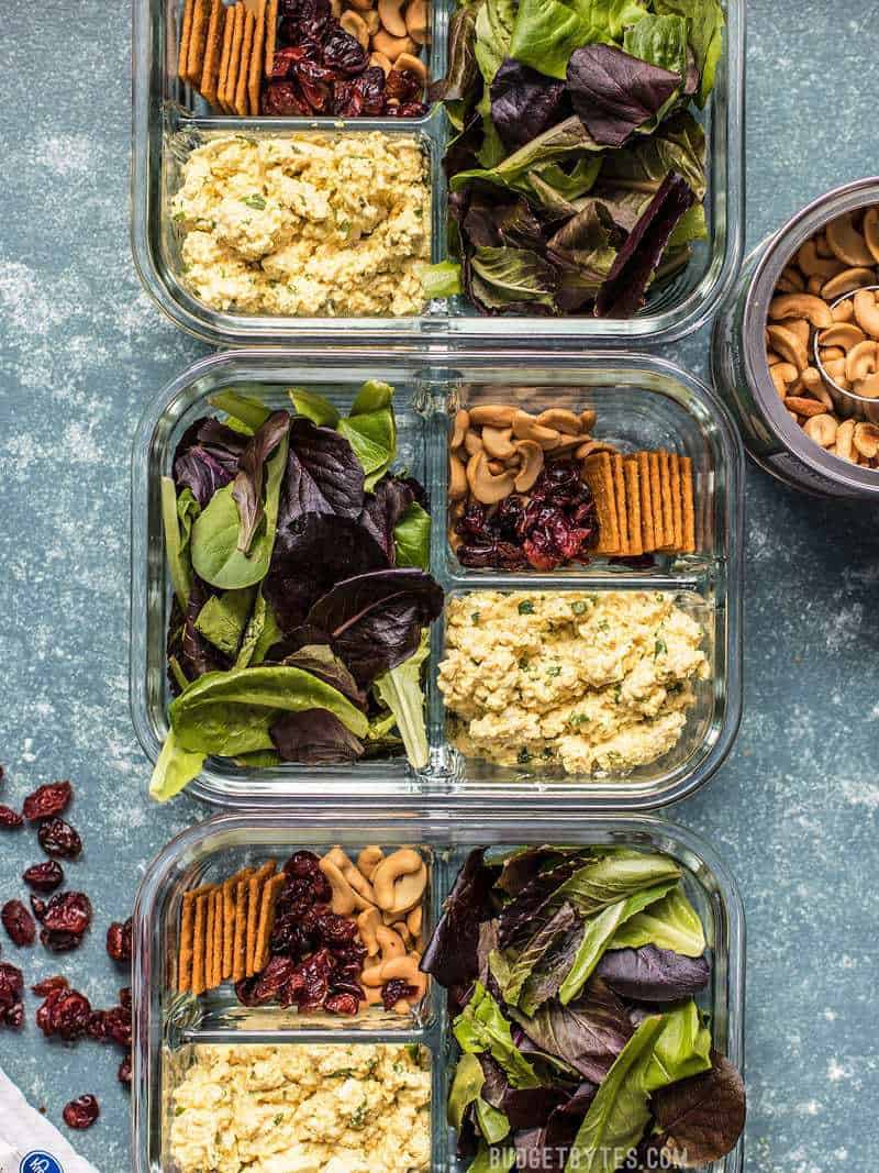 Light, filling, full of texture and flavor, this no-reheat Curried Tofu Salad Meal Prep is the perfect make-ahead lunch for summer! Budgetbytes.com Three Curried Tofu Salad Meal Prep containers with dried cranberries and cashews on the sides