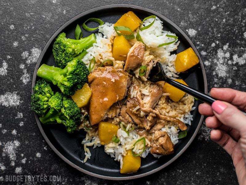 With just a few ingredients, dinner doesn’t get easier (or tastier) than this Slow Cooker Pineapple Teriyaki Chicken. Skip the take out tonight! A forkful of Slow Cooker Pineapple Teriyaki Chicken being lifted from the plate.