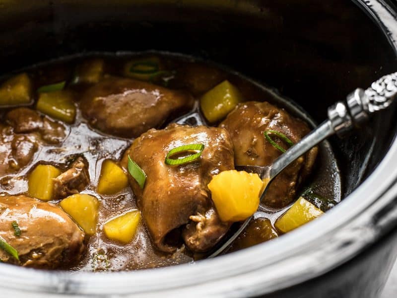 With just a few ingredients, dinner doesn’t get easier (or tastier) than this Slow Cooker Pineapple Teriyaki Chicken. Skip the take out tonight! Close side view of Slow Cooker Pineapple Teriyaki Chicken in the slow cooker