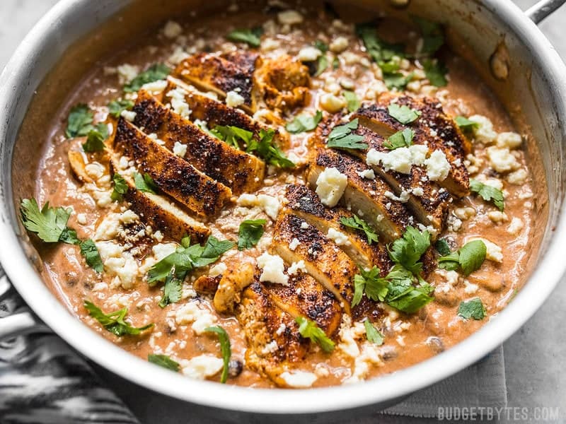 A simple jar of salsa is the key to making this fast and easy weeknight dinner. Just try this Creamy Salsa Chicken Skillet and see for yourself. Front view of sliced chicken in the skillet with a creamy salsa sauce.