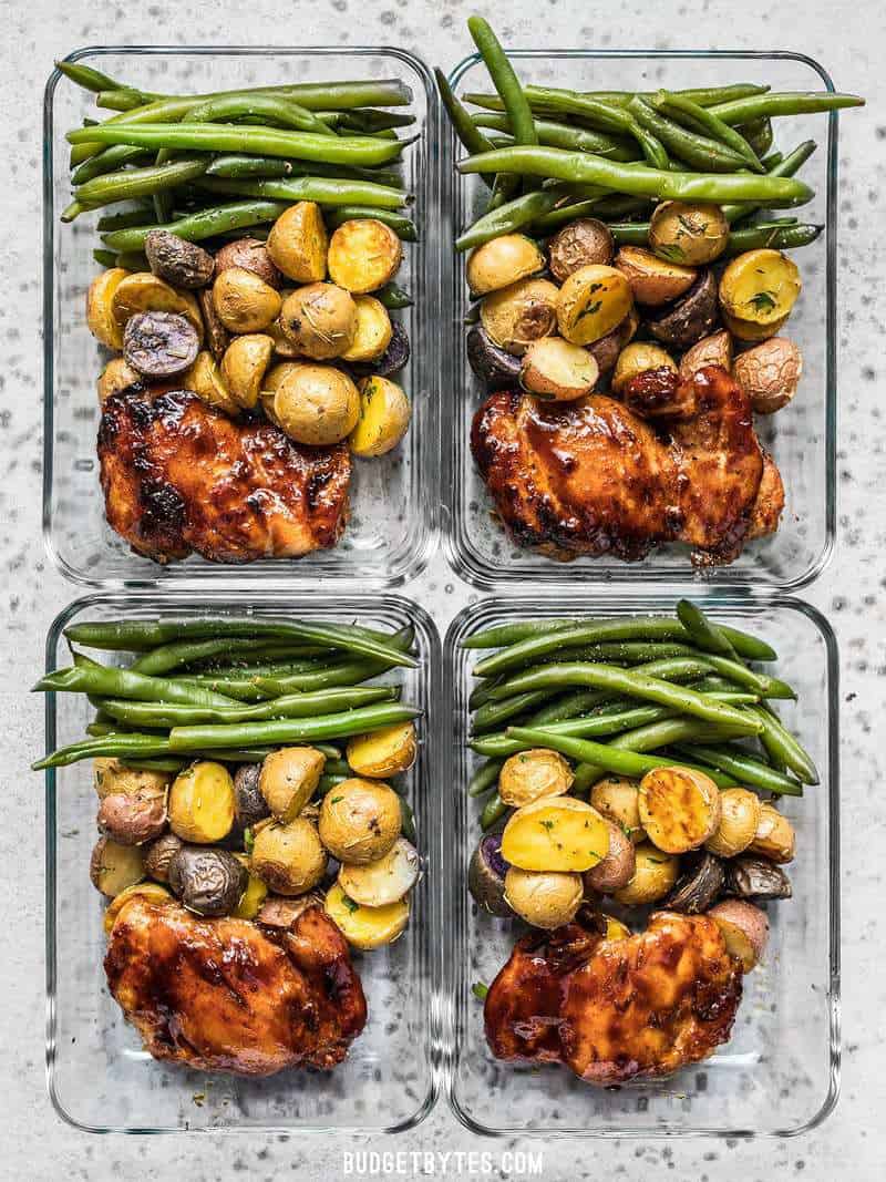 Take your meat and potatoes meal prep into the 21st century with this simple, yet elegant Glazed Chicken Meal Prep. Eating well has never been easier. Budgetbytes.com Four glass Glazed Chicken Meal Prep arranged in a rectangle