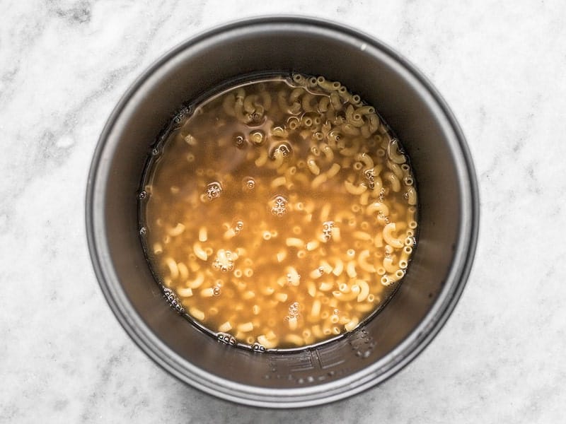 Add Macaroni and Vegetable Broth to Rice Cooker Add Macaroni and Vegetable Broth to Rice Cooker
