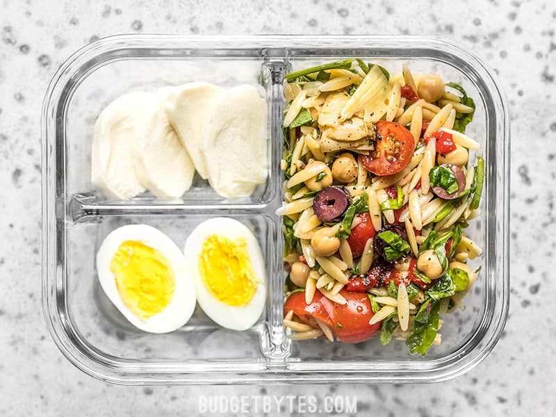Orzo Salad Meal Prep lunch box for an easy pre-made cold lunch. Budgetbytes.com Single Close Up of Orzo Salad Meal Prep Lunch Box