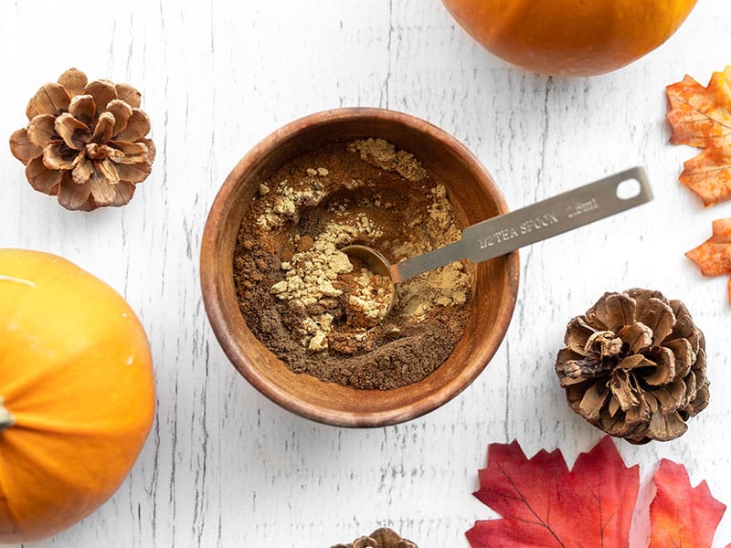 Make your own homemade pumpkin pie spice from scratch as needed for all of your fall recipes. Plus ideas for how to use pumpkin pie spice. Budgetbytes.com spices in a wooden bowl half stirred