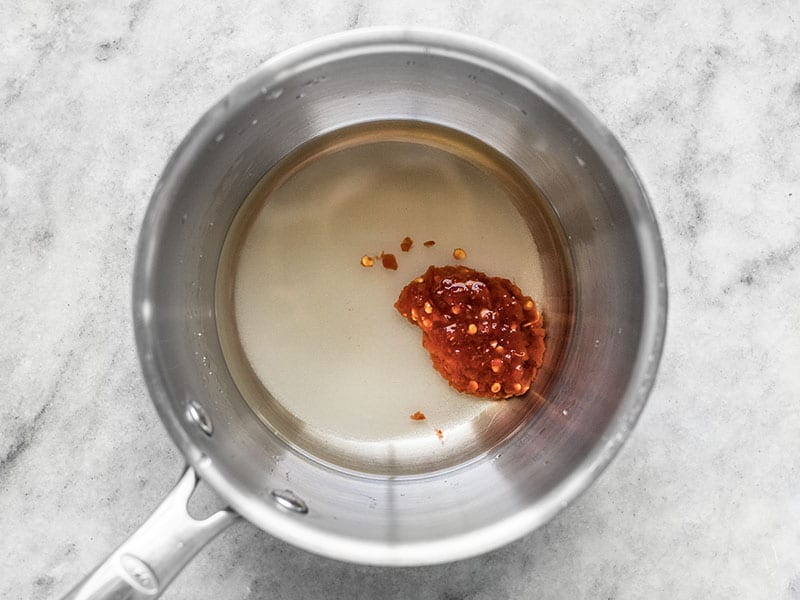 Sugar Rice Vinegar and Sambal Oelek in a pot.
