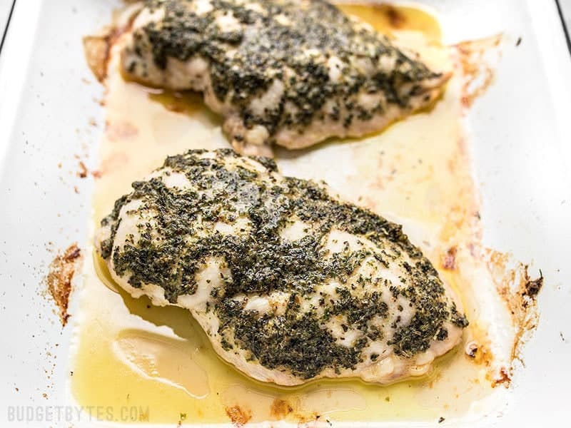 Garlic Herb Baked Chicken Breast is a fast and easy way to make juicy and flavorful chicken to add to sandwiches, wraps, pasta, salads, and more. Budgetbytes.com Garlic Herb Baked Chicken Breast in baking dish with juices.