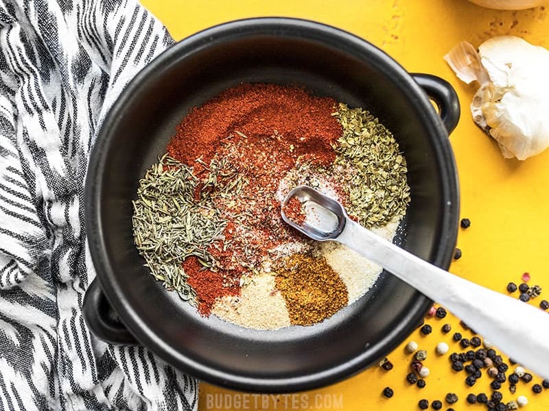This homemade Cajun Seasoning is spicy, smoky, and will add TONS of flavor to your meat, vegetables, beans, pasta, and more. Budgetbytes.com Stirring together herbs and spices for Homemade Cajun Seasoning